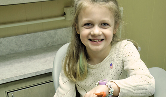 Smiling little girl in dental chair