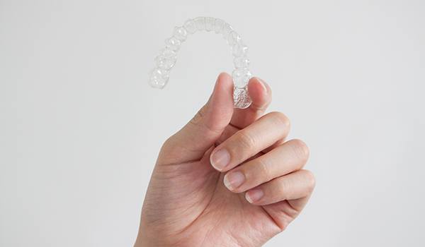 Patient holding clear aligner