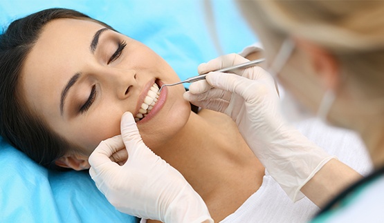 Woman having her gums examined by her dentist