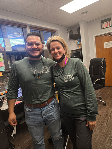 Collinsville dentists and team members wearing yellow shirts in dental office