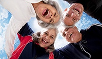 Top-up view of four friends huddling together