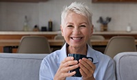 Woman smiling with a cup of coffee