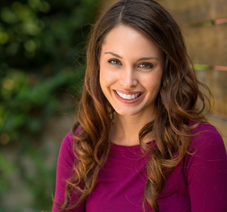 Grinning woman wearing a magenta blouse