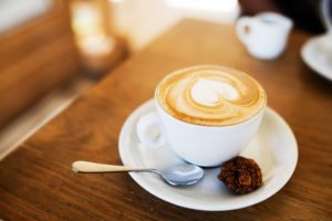 cup of coffee on plate with spoon