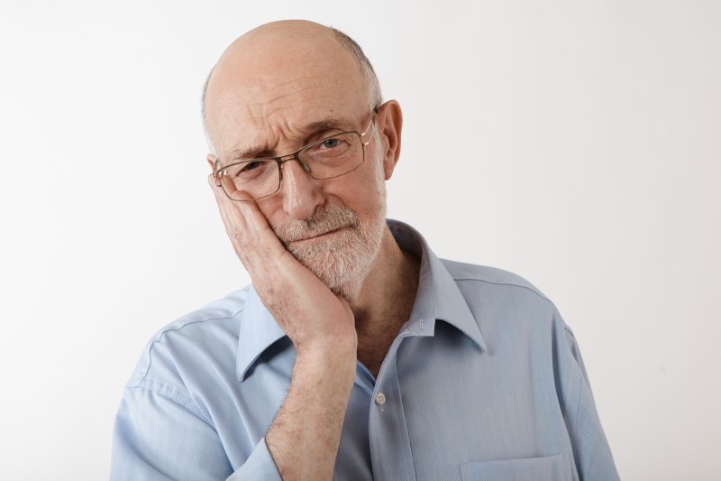 older man in pain needs emergency dentist in Collinsville