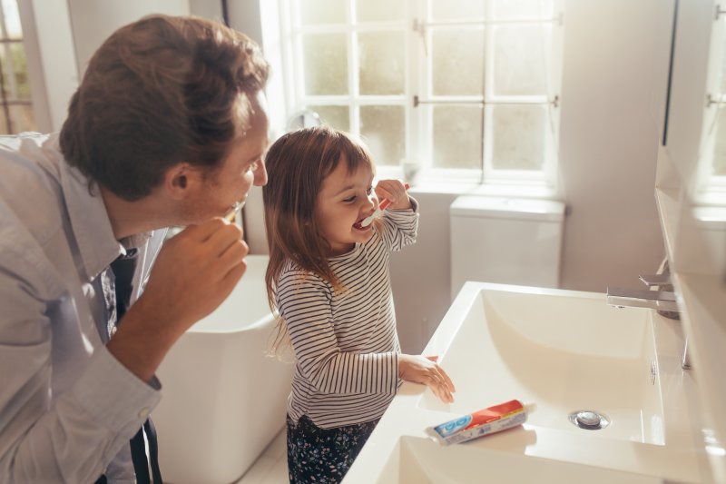 Child brushing her teeth