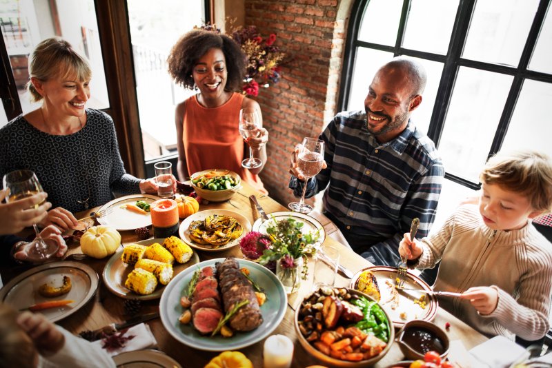 family enjoying a meal after visiting a dentist in Collinsville