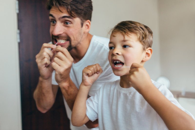 a father and son flossing together 